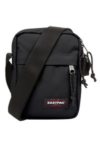 Borsa a tracolla Eastpak nera in nylon resistente. Caratterizzata da un vano principale, tasca frontale con zip e tracolla regolabile con dettagli in metallo.