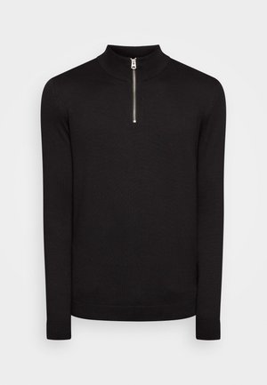 Pull-over en tricot noir avec un col haut et une fermeture éclair métallique quart de longueur. Manches ajustées et texture légère. Design global sans coutures.