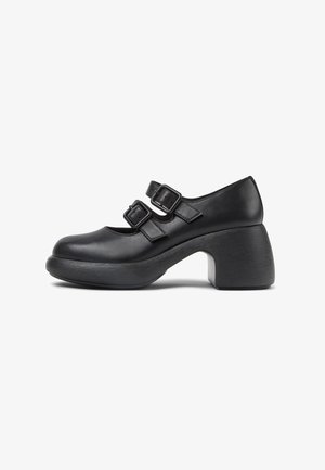Black leather shoes with two buckle straps, rounded toe, low platform, and a chunky, textured heel. Side profile view.