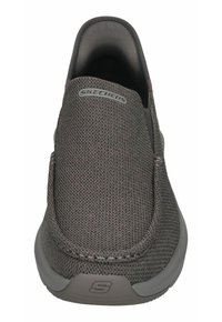 Gray slip-on shoe made of textured fabric with a smooth interior. Features a subtle Skechers logo and a flexible, cushioned sole.
