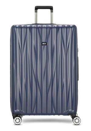 Navy hard-shell suitcase with wave-like texture, retractable handle, and four spinner wheels. Features a logo plate on the front.
