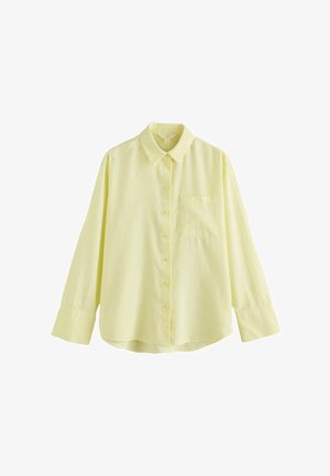 Dzeltena pogām aiztaisāma krekla ar apkakli, garām piedurknēm, vienu krūšu kabatu, izgatavota no viegla auduma, ar brīvu piegriezumu un mīkstu tekstūru.