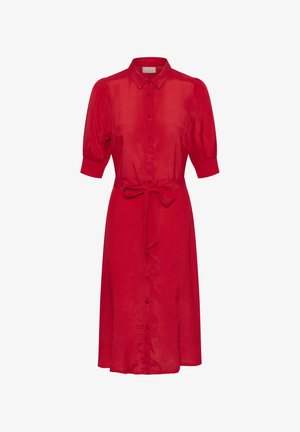 Piros len ingruha gombos előrésszel, rövid fodros ujjakkal, derékban megkötővel és bővülő szoknyával. Simább textúrájú, klasszikus gallérral.