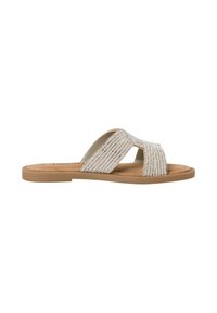 Beige slide sandals with two cross straps featuring shimmering metallic threads and a flat, tan sole. Soft footbed for comfort.
