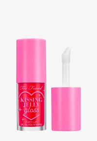 Too Faced Kissing Jelly Gloss in een heldere tube met een felroze dop, voorzien van een doe-foot applicator en een gedurfde glanzende textuur.