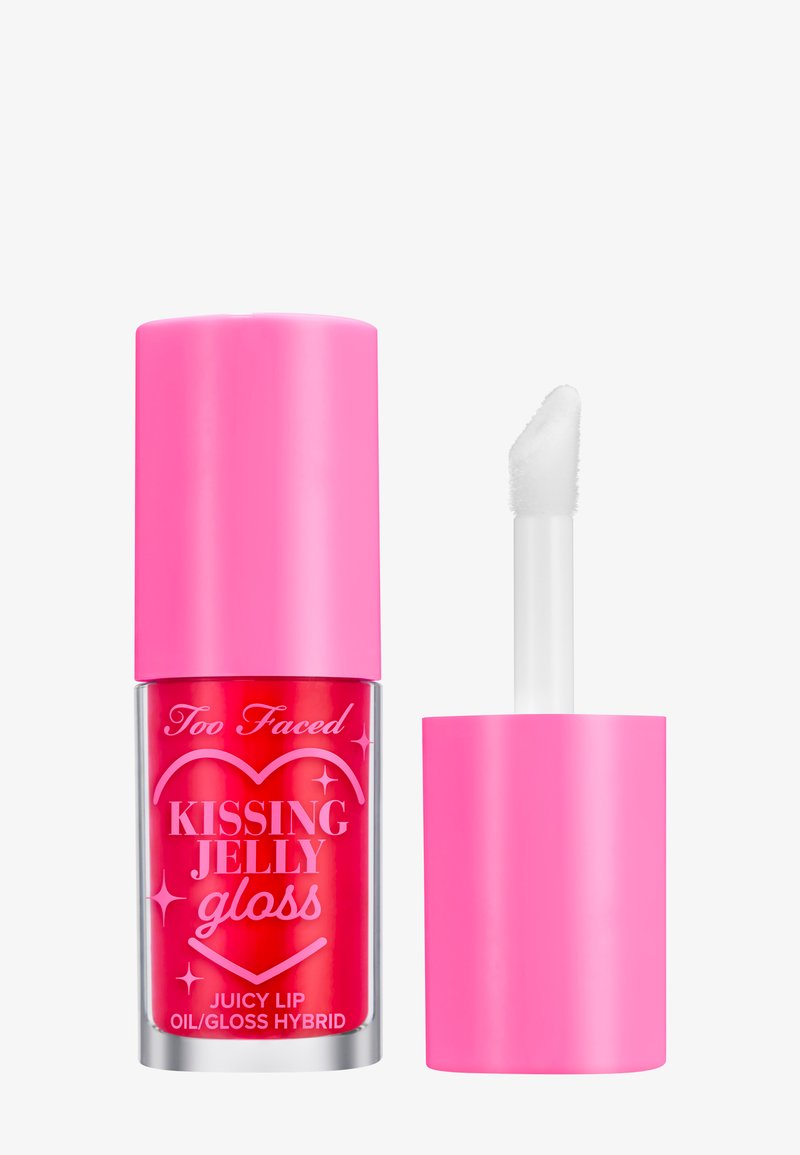 Too Faced Kissing Jelly Gloss in einem klaren Röhrchen mit einem leuchtend pinken Deckel, ausgestattet mit einem Applikator in Taubenfußform und einer kräftigen, glänzenden Textur.