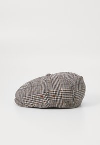 Brown and cream plaid cap with a round shape, featuring a button on top and breathable eyelet vents on the sides.