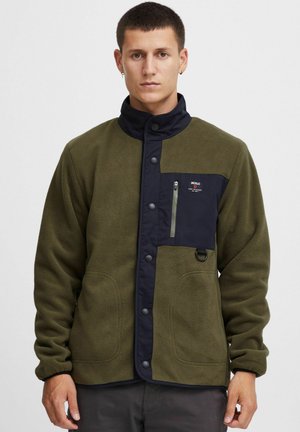 Fleece jacket in olive green with navy accents, featuring a snap closure, zippered chest pocket, and side pockets. Smooth texture with a casual fit.