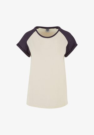 Cream-colored t-shirt with dark purple raglan sleeves, round neckline, and rolled sleeves, made from soft cotton fabric.