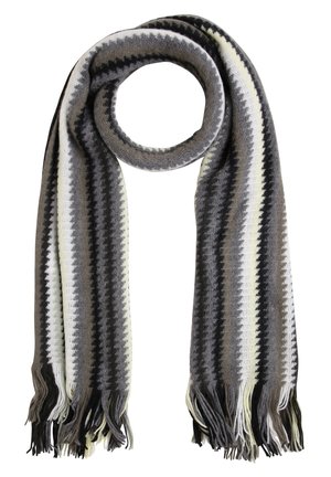 Écharpe en tricot avec des rayures en zigzag noir, blanc, gris et beige, aux extrémités frangées, présentée en boucle circulaire sur fond blanc.