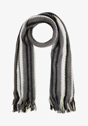 Écharpe en tricot avec des rayures en zigzag noir, blanc, gris et beige, aux extrémités frangées, présentée en boucle circulaire sur fond blanc.