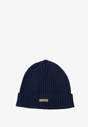 Navy ribbed beanie hat in knit material with a wide folded cuff. Features a small branded leather tag on the front.