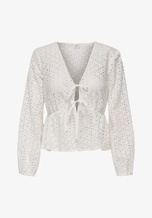 Balta peplum tipo palaidinė su ilgomis rankovėmis, V formos iškirpte, su surišimu priekyje ir akių raštu, sudaryta iš išpjovų. Tekstūruota, lengvo svorio medžiaga.