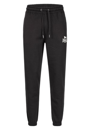 Black jogger pants made of cotton blend, featuring an elastic waistband with drawstring, cuffed ankles, and a small white logo on the side.