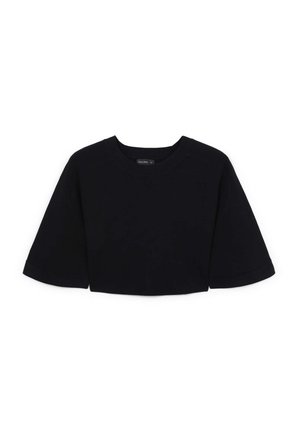 Pull court noir à manches courtes avec col rond et coupe ample, présenté sur fond blanc.