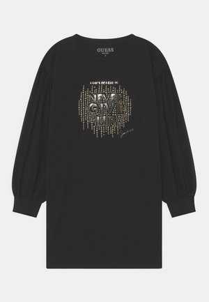 T-shirt noir à manches longues surdimensionné avec des manches ballon, orné d'un imprimé graphique argenté brillant portant l'inscription « NEVER GIVE UP » avec une signature.