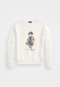 White sweatshirt featuring a graphic of a bear in a tan coat, blue sweater, denim jeans, and a cap, with a brown briefcase.