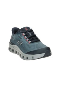 Baskets de sport étanches bleues pour hommes avec lacets noirs, semelle rembourrée avec trous de ventilation et logo de la marque sur le côté et la languette.
