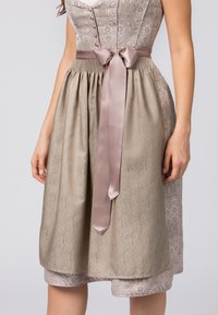 A knee-length dress featuring a textured light brown skirt, a floral-patterned bodice, and a satin mauve ribbon at the waist.