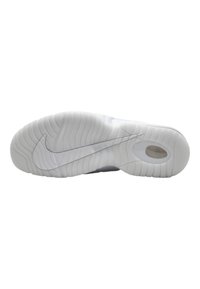 Nike sneakersål i hvid gummi med teksturerede riller. Har en cirkulær luftlomme og et fremtrædende swoosh-logo.