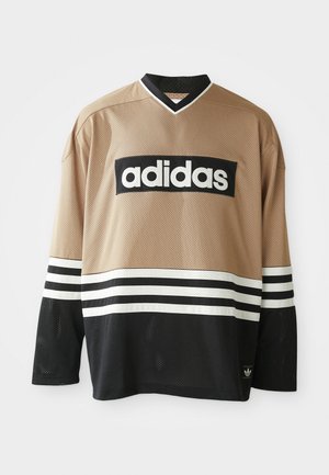 Adidas dugi rukav sportski dres u bež i crnoj boji s bijelim prugama, od mrežaste tkanine, s Adidas logotipom na prsima i donjem rubu.