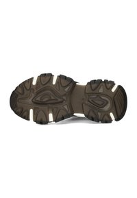 Sole of a sneaker featuring a textured, patterned design in dark brown and white, showcasing deep treads for traction.