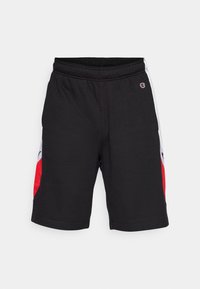 Black athletic shorts made of soft fabric, featuring side panels in red and white, with an elastic waistband and logo detail on the front.