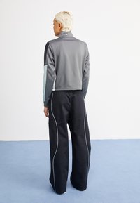 Nike Sportswear STREET - Bukser - black/light pumice white