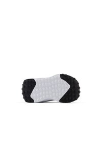 Suola di scarpa bianca e nera con superficie in gomma testurizzata, caratterizzata da motivi circolari, un tacco nero prominente e una sezione centrale bianca.
