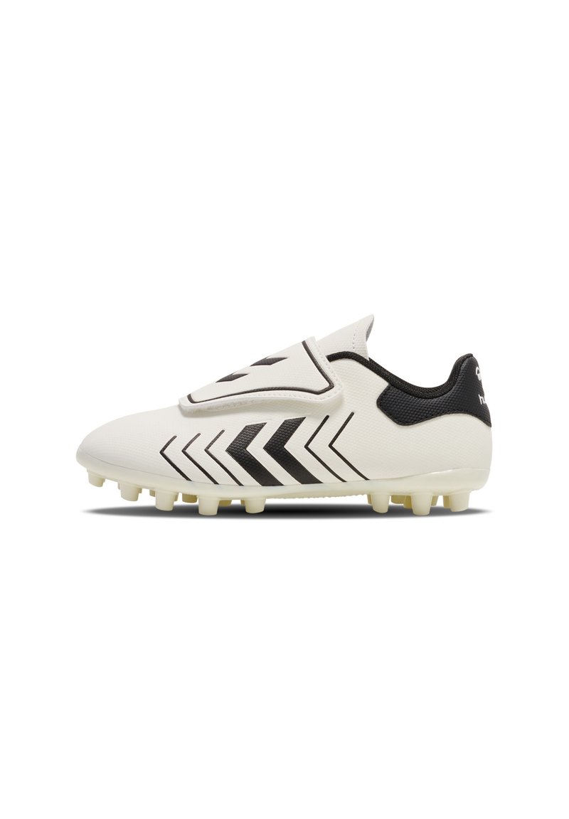 White soccer cleat with black chevron patterns, black heel detail, and fold-over tongue covering laces, designed for firm ground.