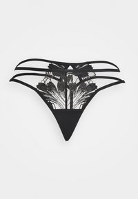 Fio dental de renda preta com padrão floral e várias tiras elásticas. O material transparente contrasta com o fundo sólido, criando um efeito em camadas.