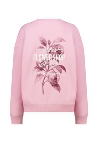 Sweat-shirt rose avec un motif floral comportant deux boules disco stylisées et un texte blanc au dos. Tissu doux en coton, poignets côtelés.