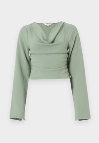 Top de manga larga recortado en suave tela texturada de color verde menta. Cuenta con un escote drapeado y un diseño ajustado, con un detalle de costura horizontal.