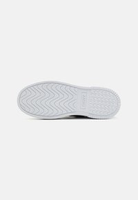 White rubber sneaker sole with a wave pattern, featuring a rectangular logo section. Smooth texture and rounded edges.