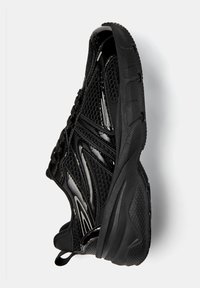 Black athletic shoe featuring a mesh upper, shiny patent accents, textured sole, and lace-up design, showcasing a streamlined silhouette.