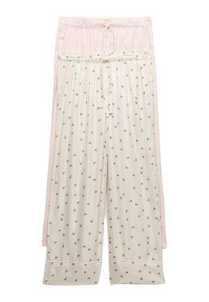 To par løse pyjamasbukser, en lyserød og en cremefarvet med små sorte hjerte-mønstre, begge med elastiske linninger og snoretræk.