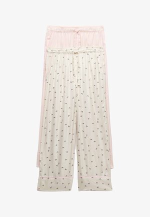 Deux pantalons de pyjama amples, l'un rose clair et l'autre crème avec de petits motifs de cœurs noirs, tous deux avec des tailles élastiques et des cordons de serrage.