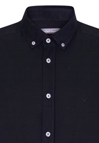 Mørk navy corduroy skjorte med knap-krave, hvide knapper og en subtil broderet logo på venstre bryst.