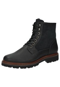 Schwarze Leder-Stiefeletten mit strukturiertem Finish, Wildlederelementen, Metallösen und rutschfester Sohle. Mit braunen Nähten entlang des Randes.
