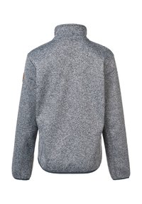 Veste en polaire grise, col haut, tissu texturé, coupe slim, avec un motif à flecks subtil. Présente des accents de couture et un petit patch logo.