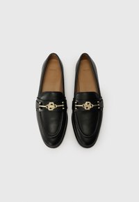 Black leather loafers with a rounded toe, featuring a gold-tone hardware accent across the vamp and smooth texture. Interior is tan.