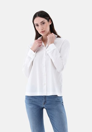 White button-up shirt with a collar, long sleeves, and a relaxed fit, made from lightweight fabric. Features front button closure and cuffs.