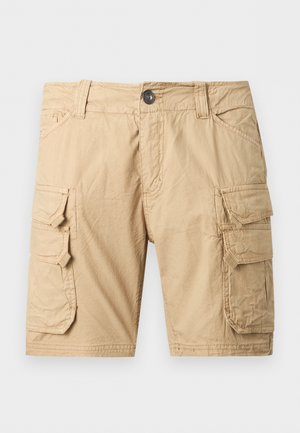 Beežid töösärgid nupuluku, vööaasad, kaks küljetaskut ja kaks suurt kaanelukke Velcro kinnitusega kummalgi säärel.