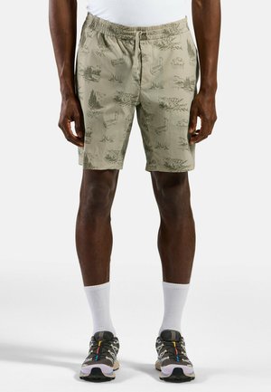 Beige Shorts mit elastischem Bund, die naturbezogene Illustrationen in dunkleren Farbtönen zeigen. Das Material ist leicht und strukturiert.