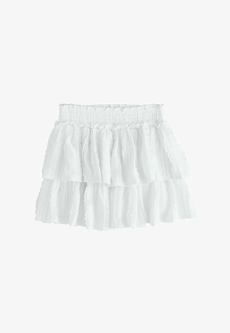 Mini jupe blanche à volants avec une taille élastiquée. Confectionnée dans un tissu léger, elle présente des bords effilochés et des volants superposés.