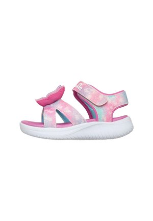 Sandalia infantil con suela blanca y tiras en tonos pastel rosa, azul y púrpura, con detalle de cola de sirena en la tira delantera.