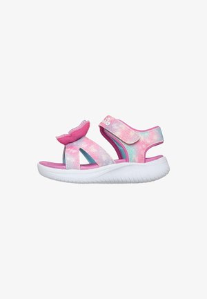 Sandalia infantil con suela blanca y tiras en tonos pastel rosa, azul y púrpura, con detalle de cola de sirena en la tira delantera.