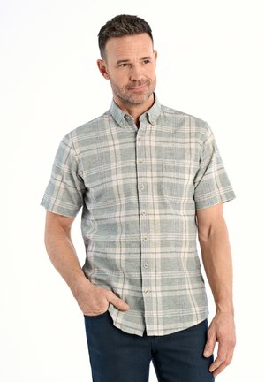 Chemise à manches courtes à carreaux dans des teintes vert clair, bleu et beige. Dotée d'un col boutonné et d'une poche sur la poitrine. Tissu doux avec une texture tissée.