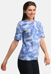 Blue short-sleeve t-shirt featuring an all-over leaf pattern, with a slightly textured fabric and a crew neckline.