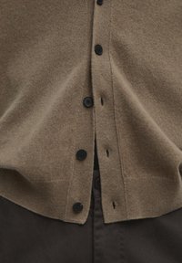 Brown wool cardigan featuring a button-down front with black buttons, textured fabric, and a V-neck design that complements dark brown pants.